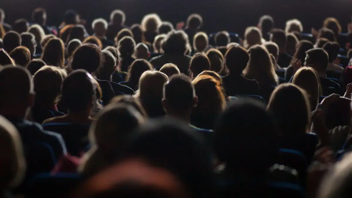 Crowd of people watching a film.